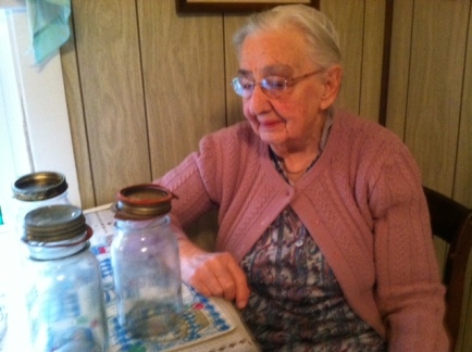 Mother saying goodbye to her canning jars before sending some of them to the Re-Use-it Shop