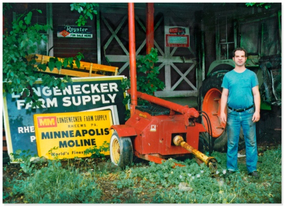 Mark in front of shop beside soybean extruder, 1984