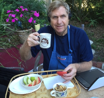 Cliff relaxes with coffee, snack and audio book in May before the frenzy began.